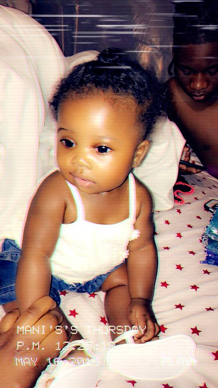 Armani is registered to the contest to win money with this photo: baby, black_hair, cheek, child, eye, face, forehead, hair, happy, head, human, lip, person, sitting, skin, smile, toddler, under_exposed