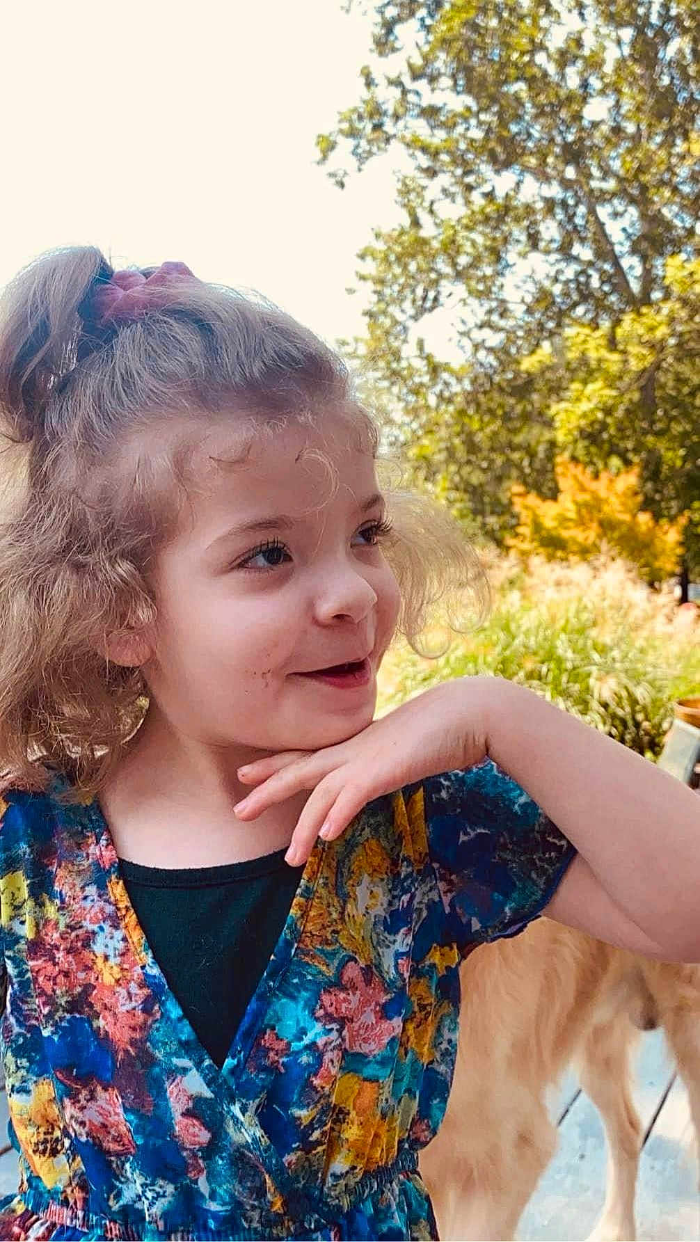 Brooklyn joined the competition — help win amazing prizes! child, girl, curly_hair, scrunchie, colorful_dress, outdoor, nature, greenery, dog, golden_retriever, pet, happy, playful, portrait, smiling, sunlight, tree, grass, person, casual_clothing