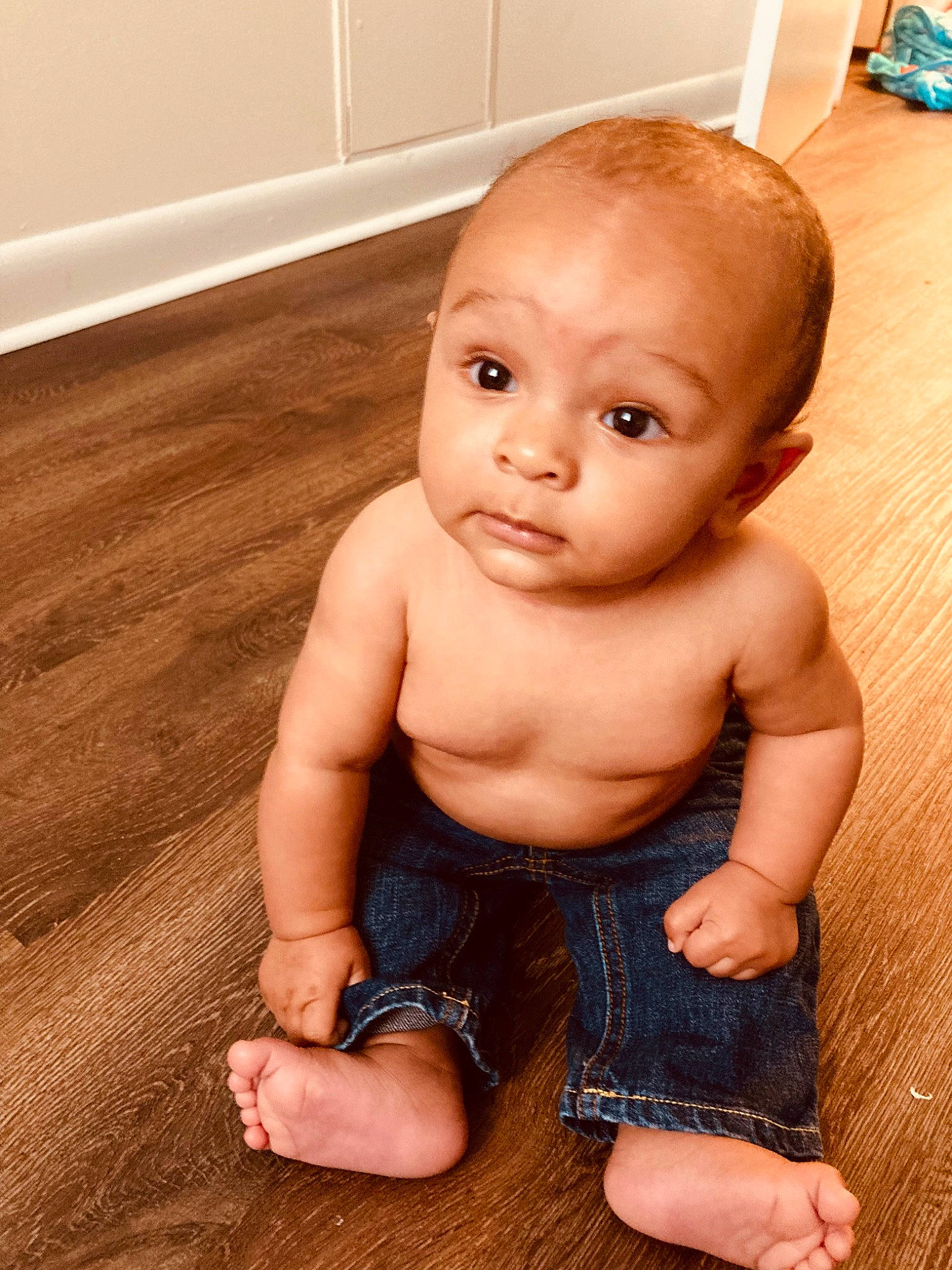 Davis is registered to the contest to win money with this photo: arm, baby, cheek, chin, eye, face, finger, floor, flooring, hand, head, human_body, iris, joint, leg, lip, mouth, muscle, nose, person