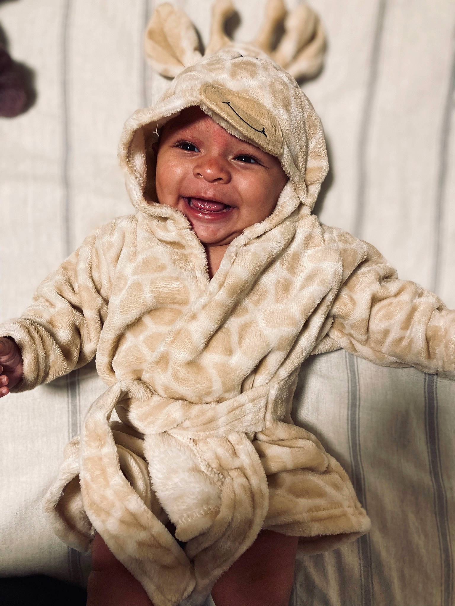 Davis joined the competition — help win amazing prizes! child, comfort, eye, fashion_design, fun, fur, fur_clothing, happy, headwear, jacket, laugh, linens, peach, person, portrait_photography, sitting, skin, sleeve, smile, toddler