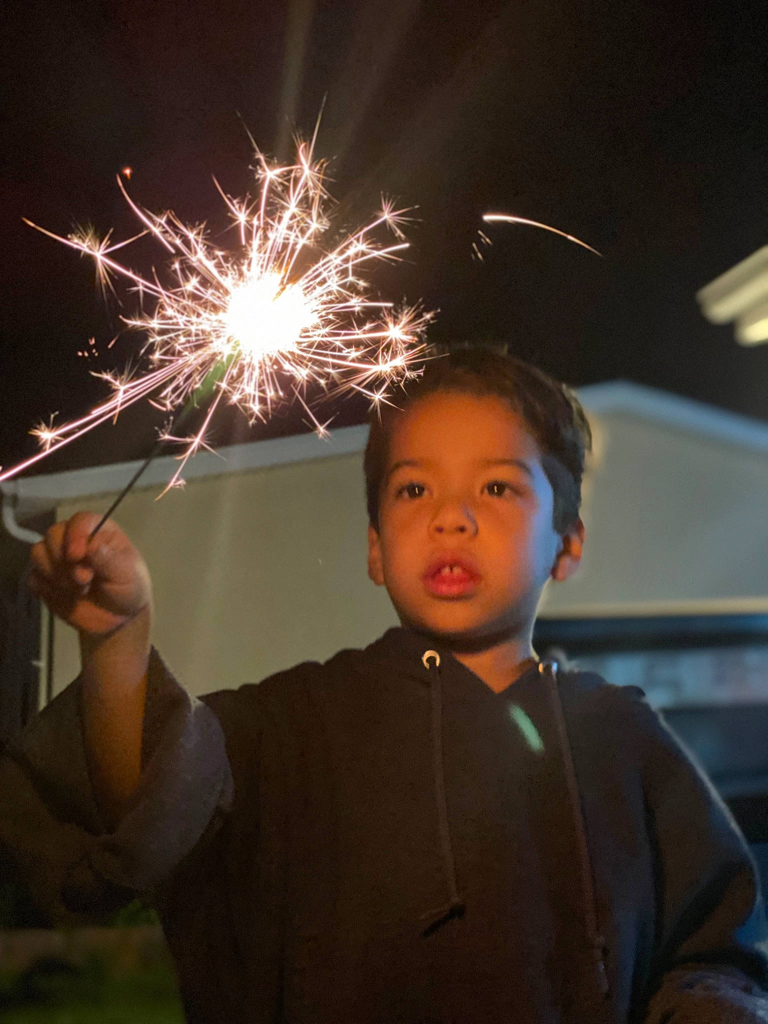 Jonathan is registered to the contest to win money with this photo: darkness, diwali, event, festival, fireworks, flash_photography, fun, gesture, happy, heat, holiday, lens_flare, midnight, new_year, new_years_day, party_supply, person, recreation, space, t_shirt