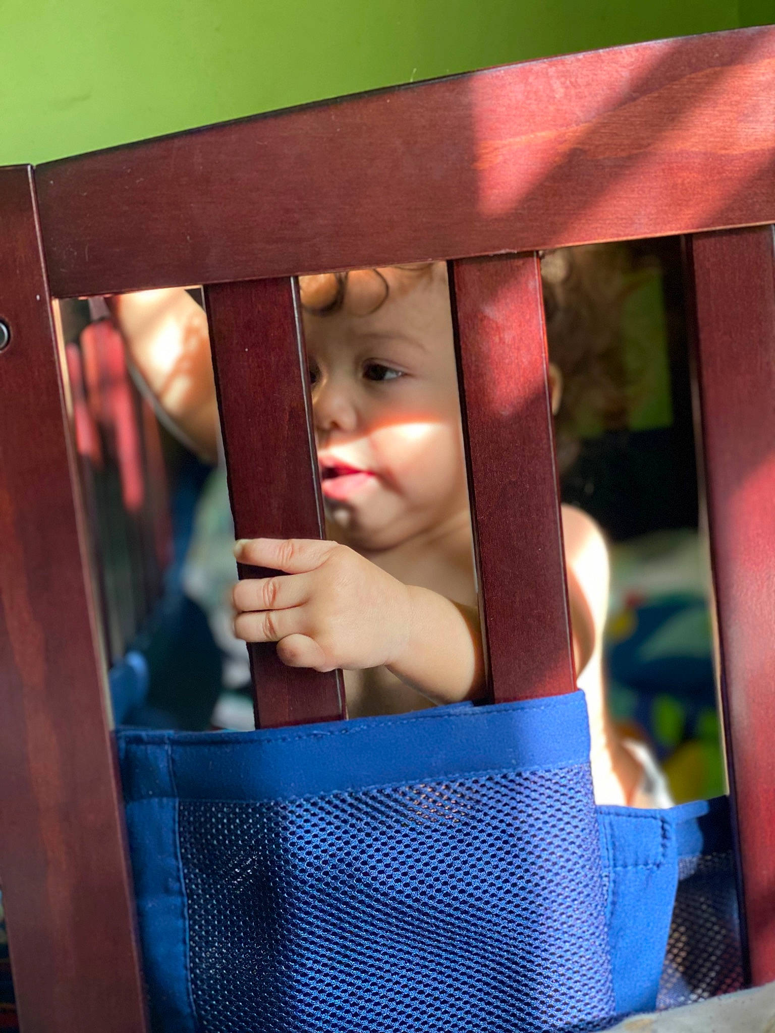 Adrien is registered to the contest to win money with this photo: baby, baby_products, baby_safety, child, chin, electric_blue, fashion_accessory, fun, hand, happy, hardwood, headwear, leisure, magenta, person, play, room, sitting, swing, tints_and_shades