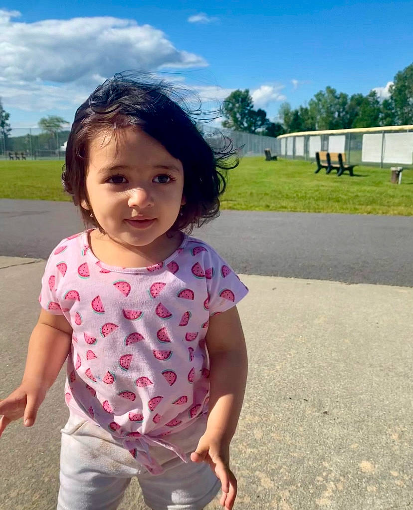 Kaneesha is registered to the contest to win money with this photo: asphalt, baby_toddler_clothing, child, cloud, fun, grass, happy, leisure, magenta, pattern, person, plant, recreation, skin, sky, sleeve, summer, toddler, travel, tree