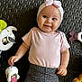adorable, baby, child, closeup, cute, floor_mat, happy, headband, indoor, infant, lying_down, pink_clothing, playtime, plush_toy, polka_dot, portrait, small_child, smiling, soft_toys, toy