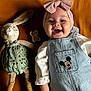 Haïvie participe au concours pour gagner de l'argent avec cette photo : baby, bow, bunny, child, clothing, cute, denim_overalls, happy, headband, indoor, infant, laying_down, mickey_mouse, mustard_background, pacifier, person, plush_toy, portrait, smiling, soft_toy