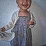toddler, child, smiling, dress, cardigan, paper, happy, indoors, person, wall, floor, button, clothing, portrait, standing, cute, young, expression, holding, fashion