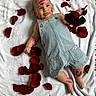 Eden a rejoint le concours — aidez-le/la à gagner de superbes lots ! baby, infant, denim_overalls, rose_petals, red_rose, lipstick_marks, blanket, lying_down, cute, smiling, face, skin, hand, foot, flower, soft_texture, child, adorable, playful, portrait