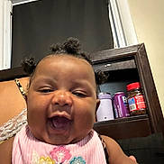 Loyal joined the competition — help win amazing prizes! baby, infant, child, smiling, happy, portrait, close_up, indoor, pink_outfit, floral_clothing, flowers, curly_hair, open_mouth, sitting, mirror, window, furniture, household, bottles, daylight