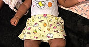 Loyal joined the competition — help win amazing prizes! baby, infant, child, portrait, lying_down, pacifier, headband, bow, hello_kitty, dress, clothing, plush_toy, giraffe, blanket, floral_pattern, bed, indoor, smiling, dark_blanket, photography