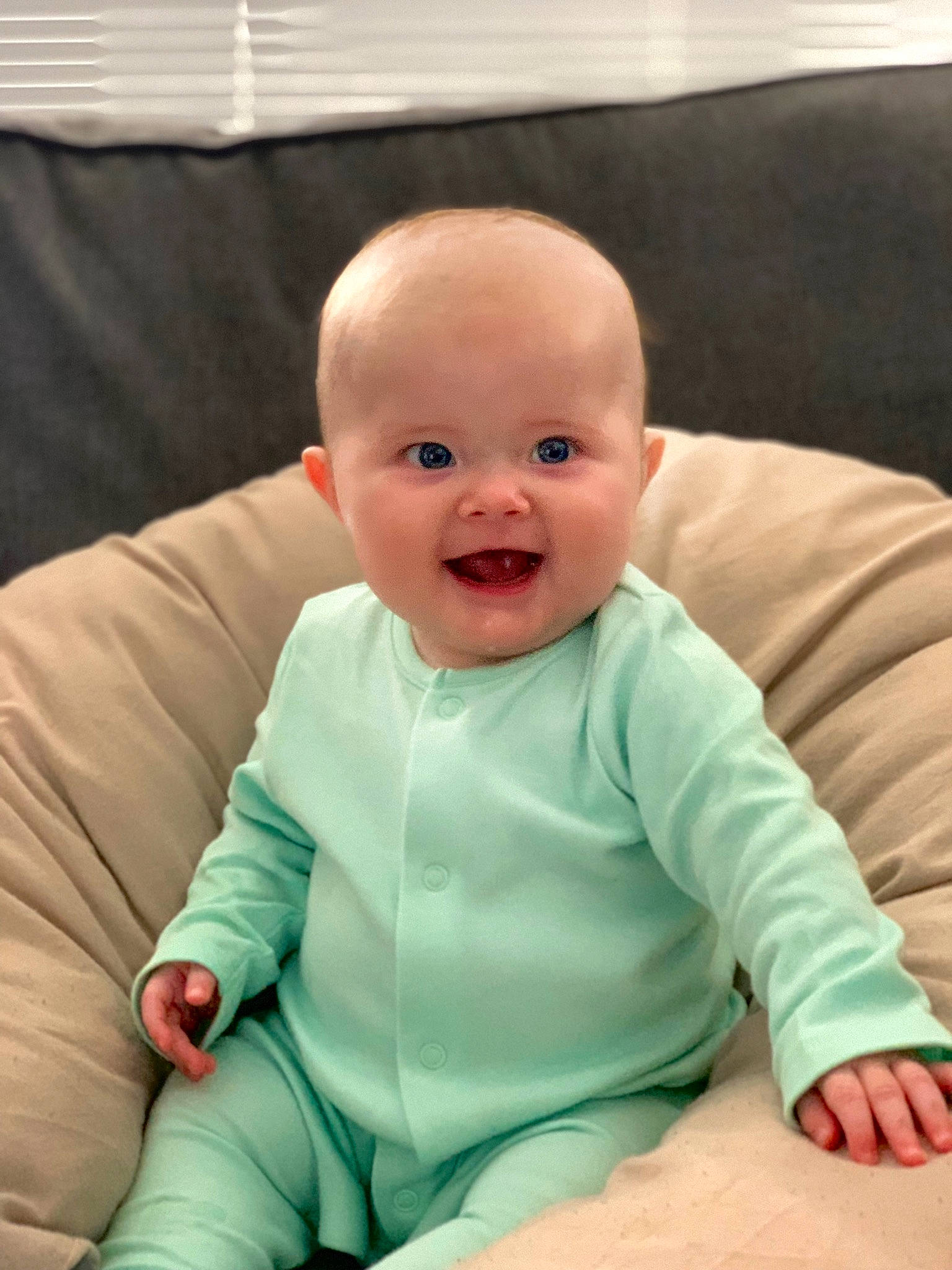 Lili is registered to the contest to win money with this photo: baby, baby_products, baby_toddler_clothing, cheek, child, chin, comfort, eye, fun, happy, head, human_body, linens, person, sitting, skin, sleeve, smile, t_shirt, thumb