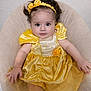 Dalia is registered to the contest to win money with this photo: adorable, baby, child, closeup, curly_hair, cushion, cute, face, fashion, happy, headband, indoor, infant, person, portrait, seated, smile, soft_lighting, tulle_skirt, yellow_dress