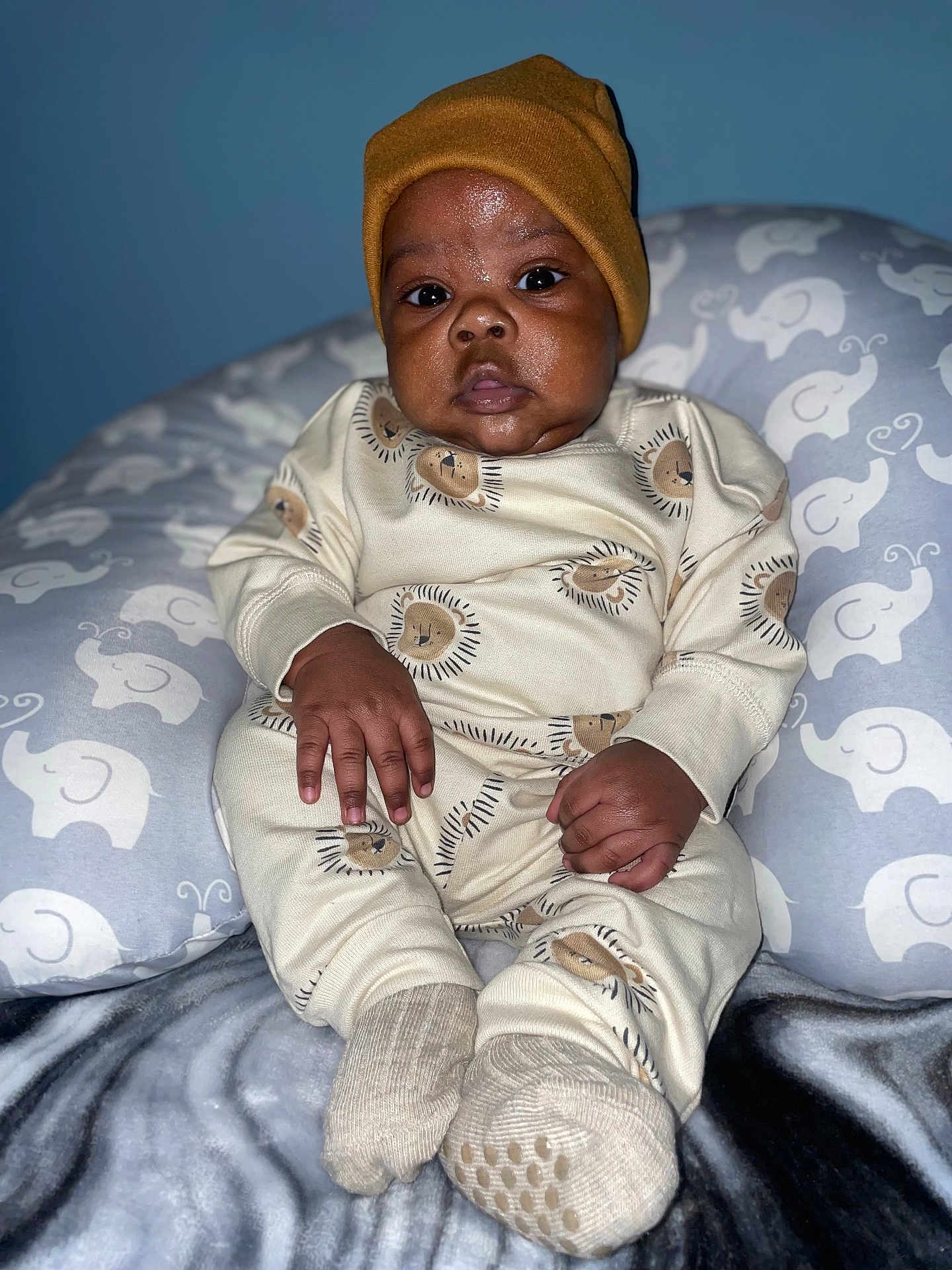 Nova joined the competition — help win amazing prizes! baby, infant, child, pajamas, beanie, hat, socks, cushion, elephant_pattern, pillow, blanket, indoor, portrait, closeup, cute, cozy, sitting, face, hands, expression