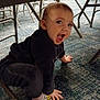 toddler, child, crawling, indoor, carpet, chairs, metal, clothing, socks, happy, expression, floor, playful, young_child, person, furniture, smiling, cute, baby, candid