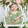 Willow joined the competition — help win amazing prizes! baby, child, smiling, flower_crown, green_dress, chair, flowers, floral_background, portrait, cute, happy, sitting, innocent, studio_photo, decor, white_chair, tulle_dress, young_child, headband, nature_inspired