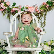 Willow joined the competition — help win amazing prizes! baby, child, green_dress, floral_crown, white_chair, flowers, pink_flowers, white_flowers, greenery, smiling, sitting, portrait, innocence, happy, cute, decor, background, nature, toddler, studio_photo
