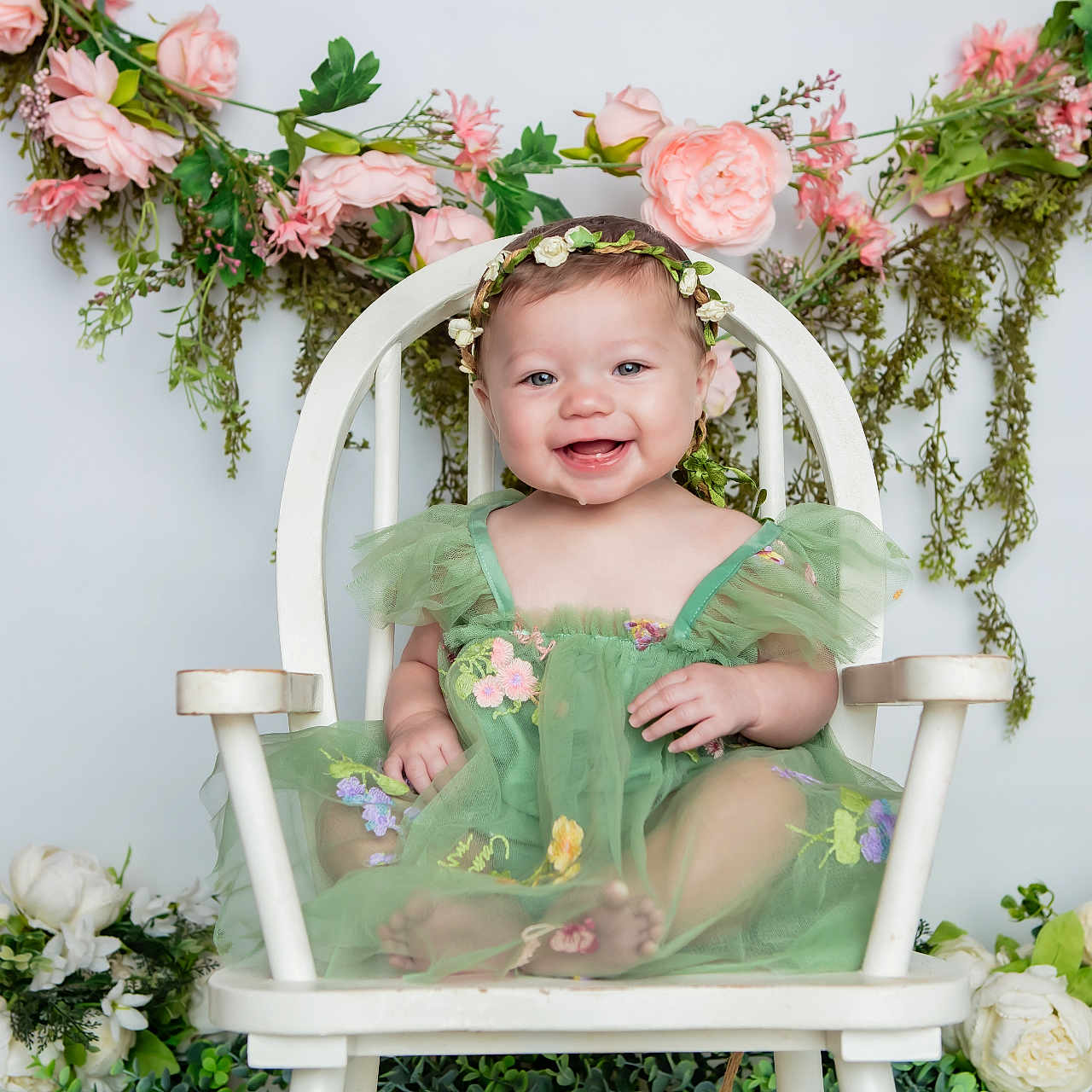 Willow joined the competition — help win amazing prizes! baby, child, smiling, green_dress, flower_crown, white_chair, pink_flowers, white_flowers, floral_arrangement, happy, portrait, cute, toddler, indoors, decor, nature, plants, sitting, celebration, joy