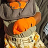 baby, infant, mittens, bib, animal_print, pants, clothing, lying_down, bed, cute, child, face, portrait, orange, gray, soft_toys, fabric, young, person, indoors