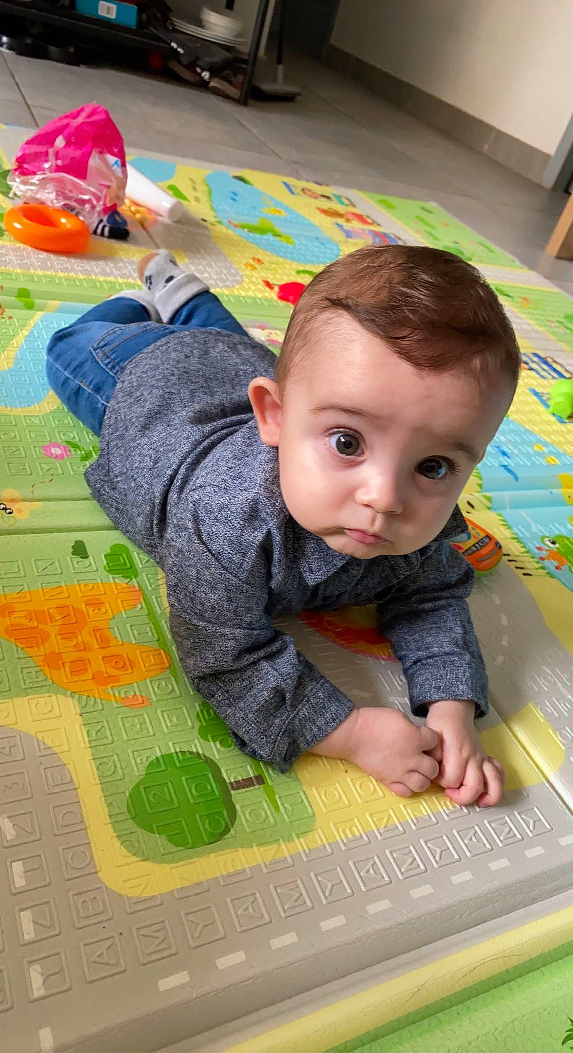 Nolan participe au concours pour gagner de l'argent avec cette photo : adaptation, art, baby, baby_toddler_clothing, cheek, child, flooring, fun, grass, green, learning, leisure, linens, pattern, person, play, playmat, room, sitting, toddler