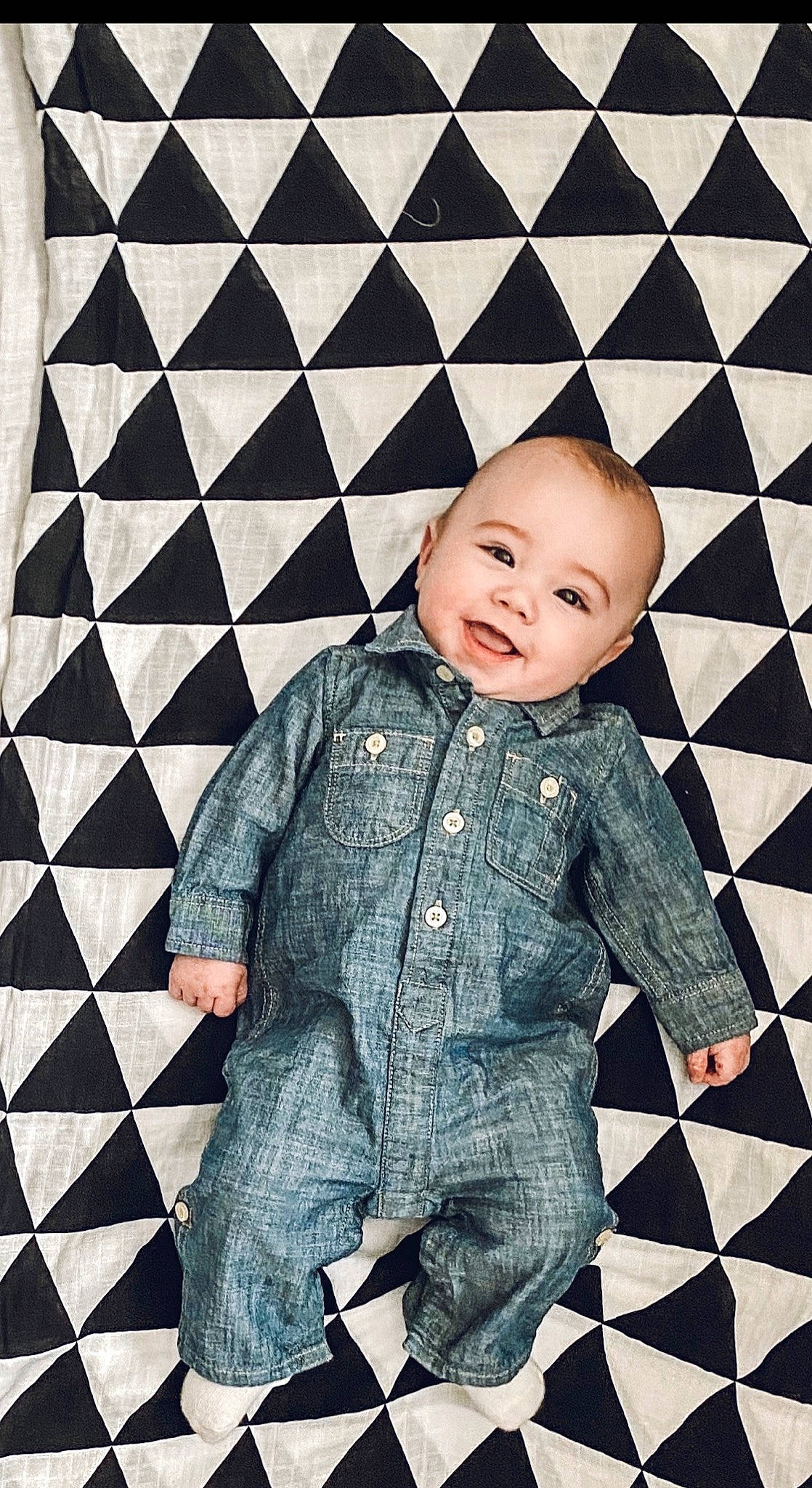 Oakland is registered to the contest to win money with this photo: baby, child, design, outerwear, pattern, person, photograph, photography, portrait, sleeve, smile, toddler