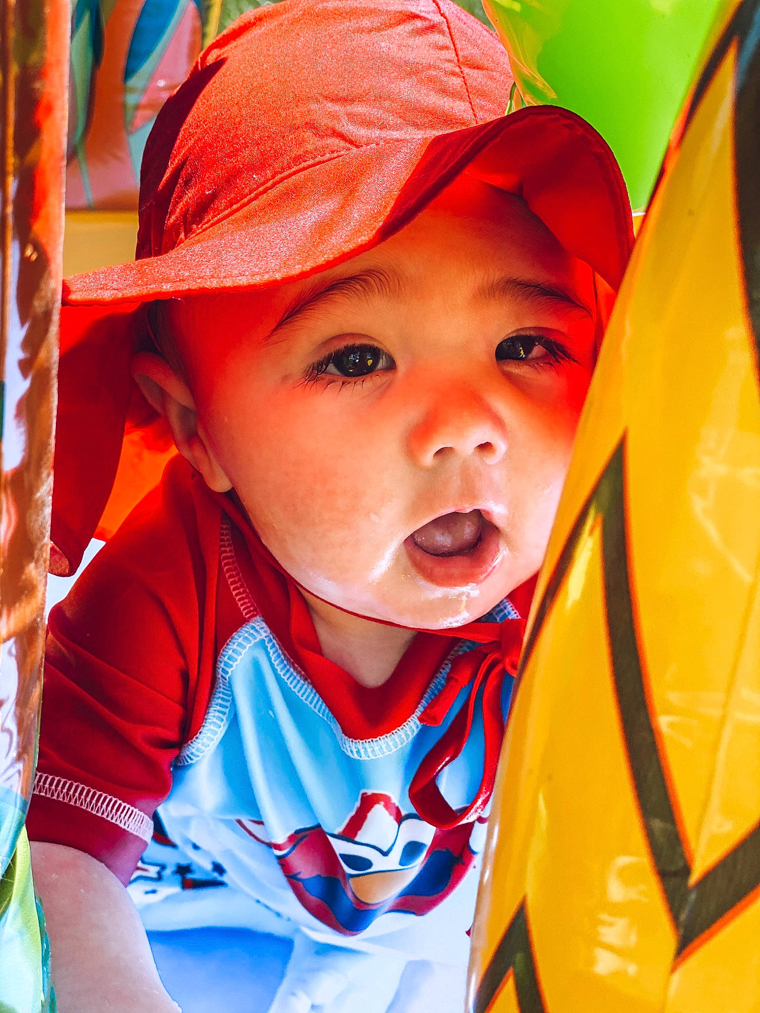 Oakland is registered to the contest to win money with this photo: baby, cheek, child, close_up, eye, face, fun, head, headgear, headwear, lip, mouth, nose, orange, person, play, product, red, skin, smile