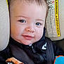 Haidyn joined the competition — help win amazing prizes! baby, child, face, smile, car_seat, seatbelt, clothing, zipper, toy, warning_label, black_jacket, infant, closeup, straps, cute, indoors, young_child, person, happy, head