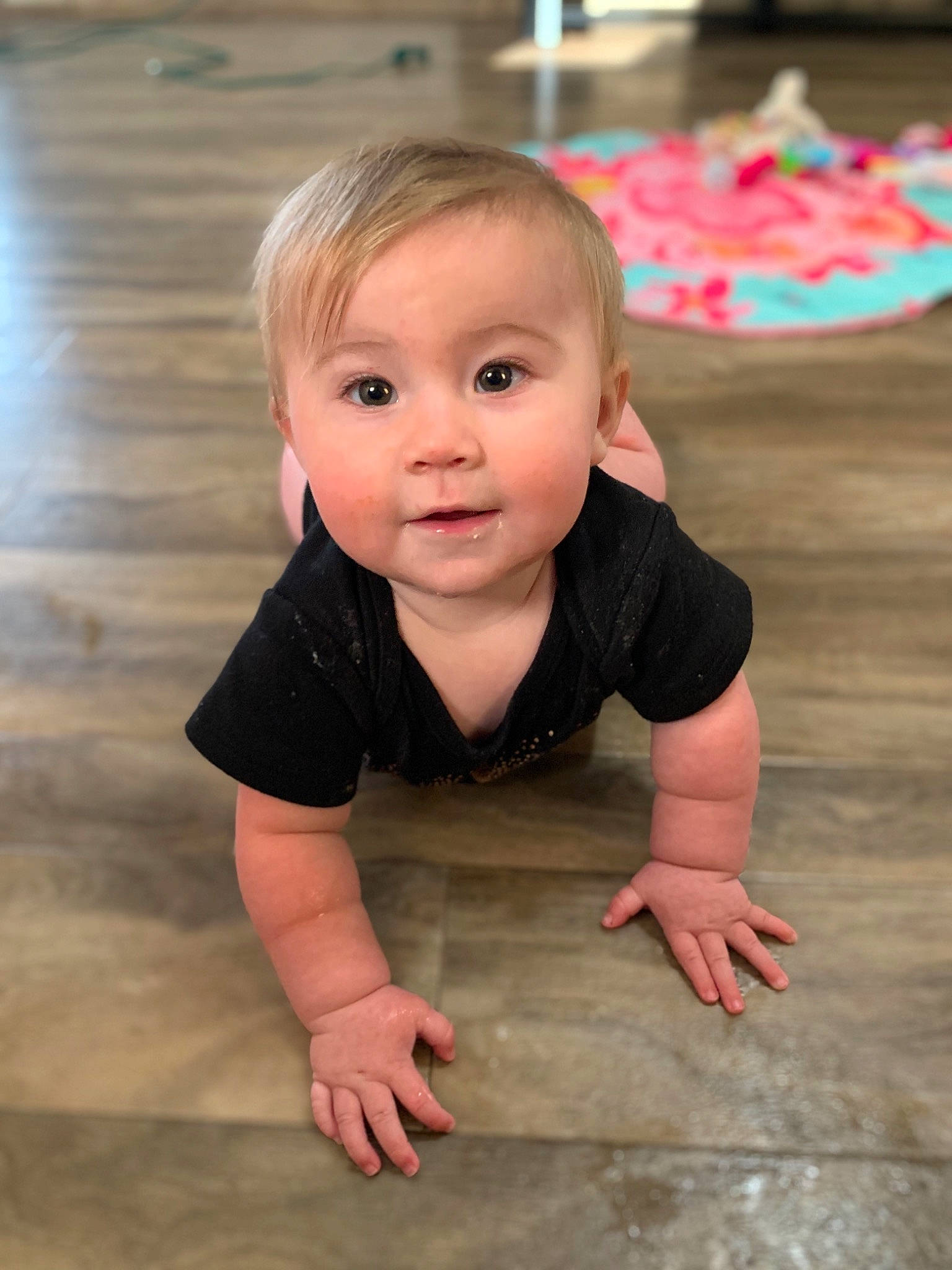 Taizleigh is registered to the contest to win money with this photo: baby, cheek, child, crawling, face, floor, flooring, person, pink, play, sitting, skin, smile, toddler, tummy_time, wood