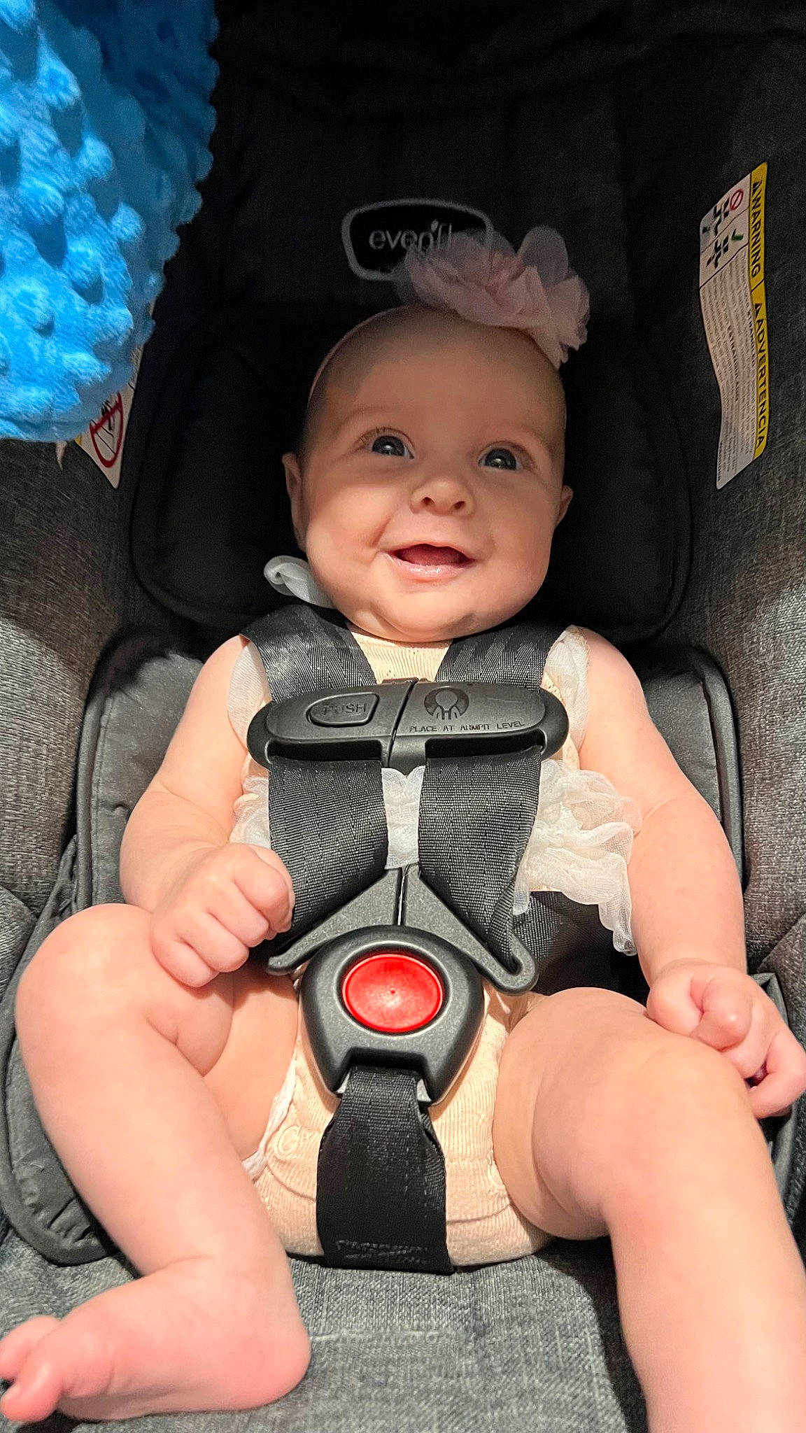 Adelynn is registered to the contest to win money with this photo: baby, baby_carriage, baby_products, baby_toddler_clothing, blue, cheek, child, comfort, eye, face, finger, head, headwear, human_body, joy, person, pink, product, skin, smile