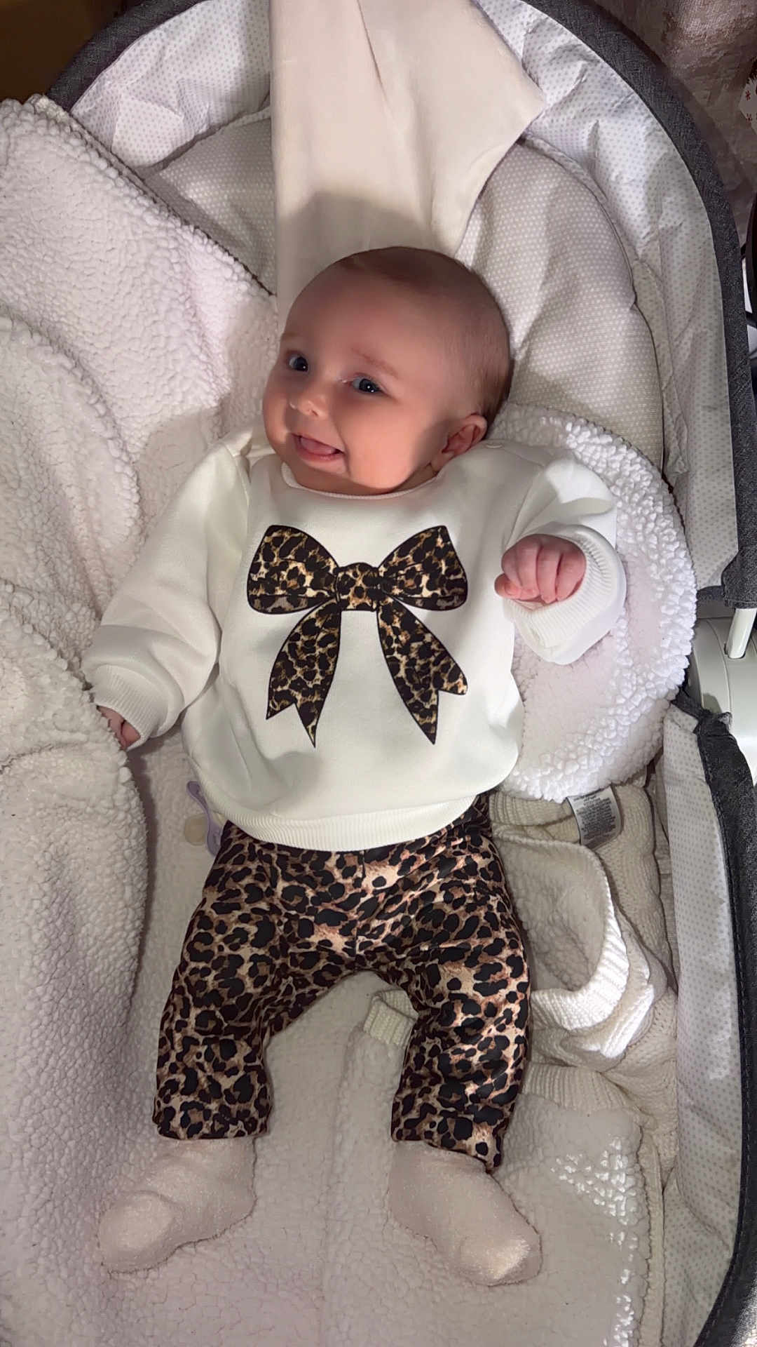 Cleo joined the competition — help win amazing prizes! baby, infant, smiling, leopard_print, sweater, pants, socks, blanket, bassinet, cozy, cute, child, clothing, indoor, soft, happy, portrait, newborn, resting, warm