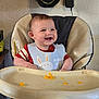 Colton joined the competition — help win amazing prizes! baby, high_chair, bib, smiling, food, orange_food, teeth, indoor, wall, charger, bag, clothing, person, cute, happy, child, feeding, seat, furniture, table
