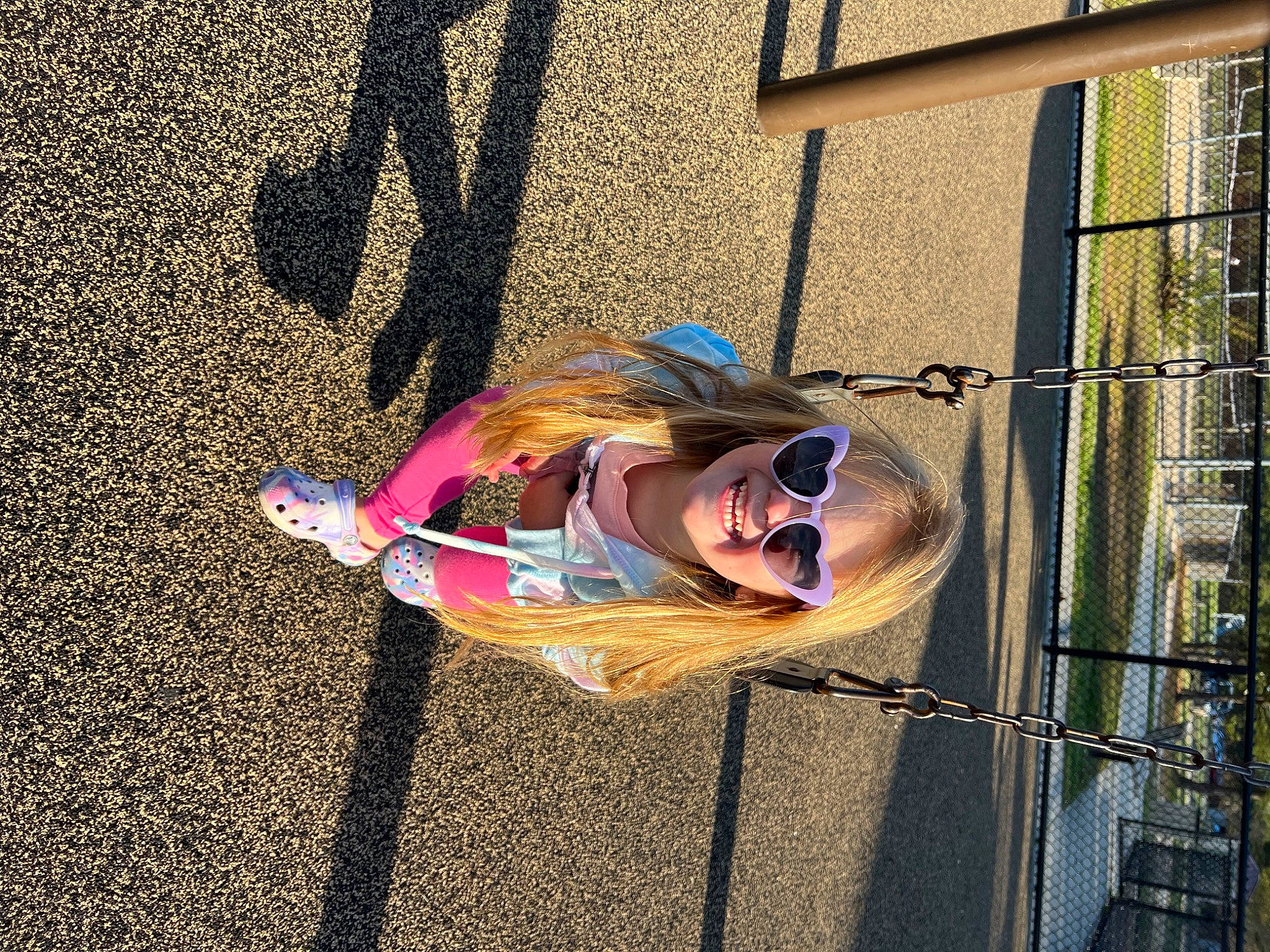 Ellie is registered to the contest to win money with this photo: asphalt, city, concrete, eyewear, fun, happy, joy, leisure, magenta, metal, person, recreation, road_surface, shadow, smile, sunglasses, tints_and_shades, toddler, vision_care, visual_arts