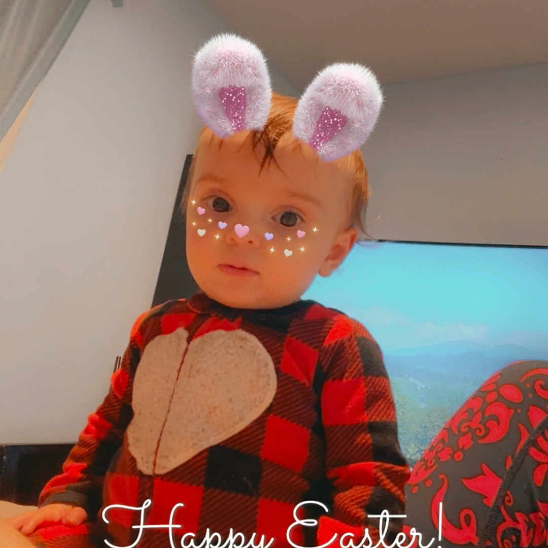 Taylor is registered to the contest to win money with this photo: child, toddler, pajamas, indoor, digital_filter, bunny_ears, heart_shape, face_decoration, television, screen, patterned_clothing, red, black, plaid, sitting, holiday_text, easter, cute, young_child, portrait