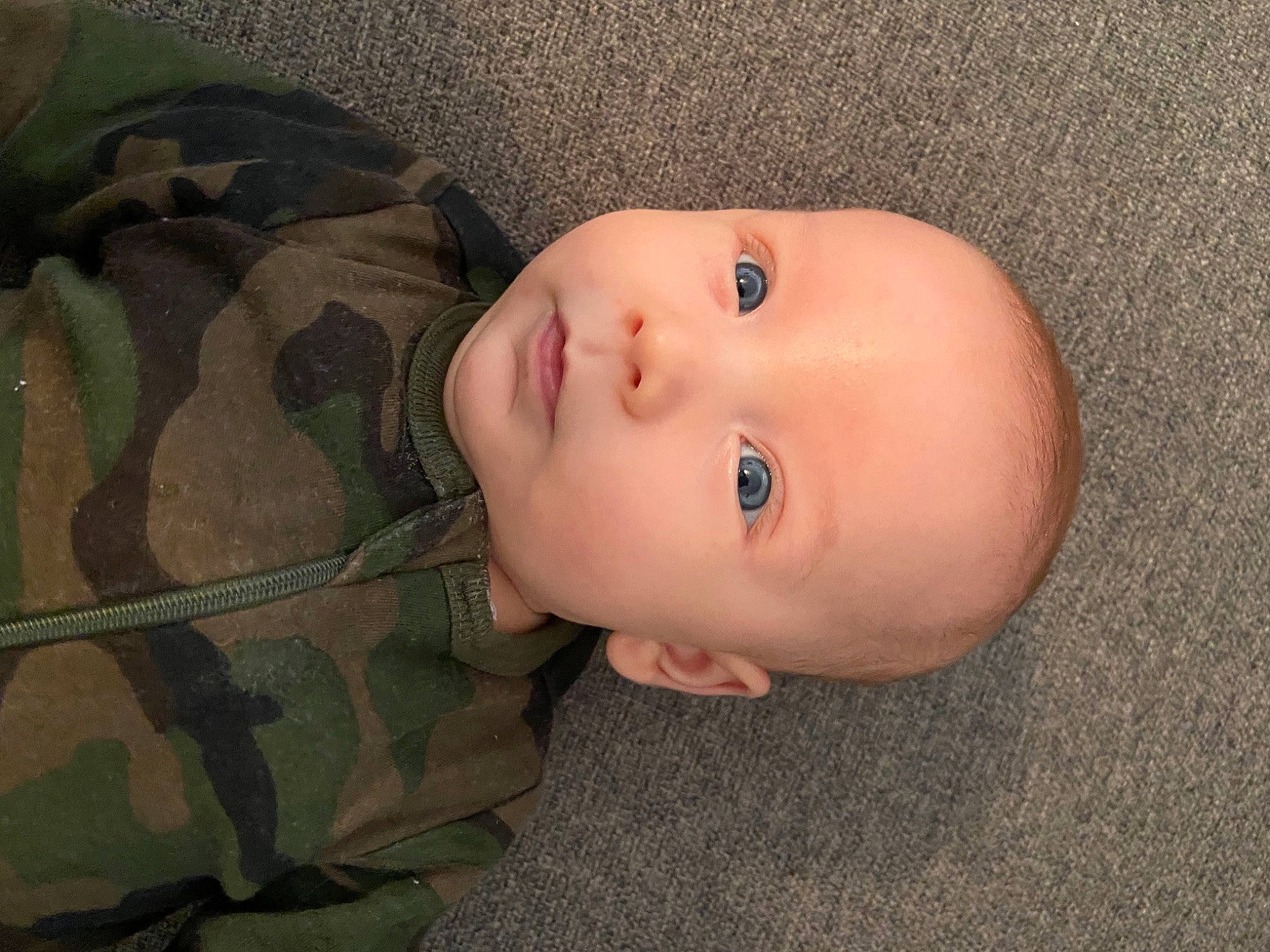 Rowan joined the competition — help win amazing prizes! baby, baby_toddler_clothing, camouflage, cheek, child, eye, eyebrow, eyelash, flooring, grass, head, human_body, iris, military_camouflage, nose, pattern, person, sleeve, toddler, tree