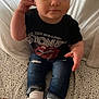 baby, bodypart, clothing, cushion, face, finger, footwear, hand, happy, head, homedecor, hosiery, jeans, pants, person, photography, portrait, sitting, sock, t_shirt