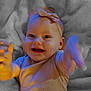 Evelyn is registered to the contest to win money with this photo: baby, blanket, blue_light, bow, child, closeup, clothing, cute, expression, face, hand, happy, headband, infant, lying_down, orange_light, portrait, reaching, smiling, soft_texture