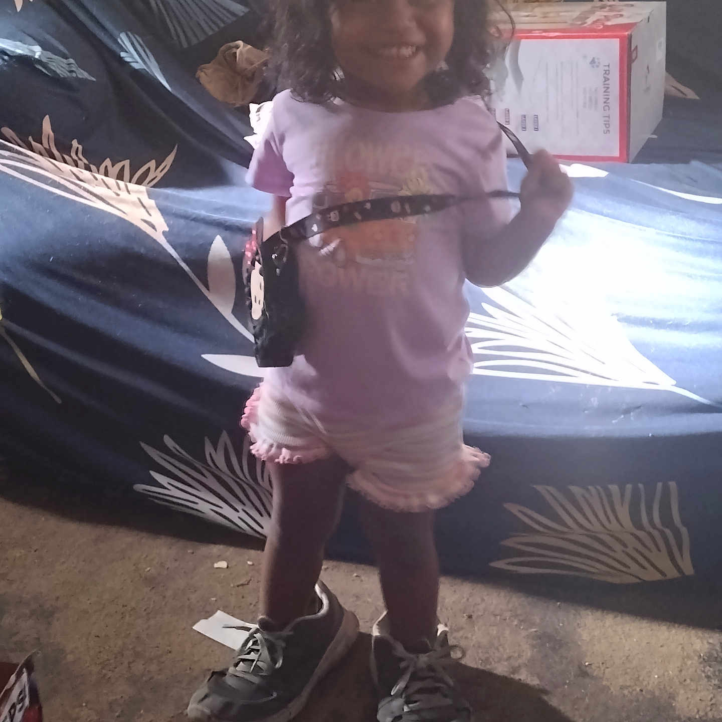 Haislynn is registered to the contest to win money with this photo: box, car, child, clothing, face, female, footwear, girl, head, pants, person, photography, portrait, runningshoe, shoe, shorts, sneaker, t_shirt, transportation, vehicle