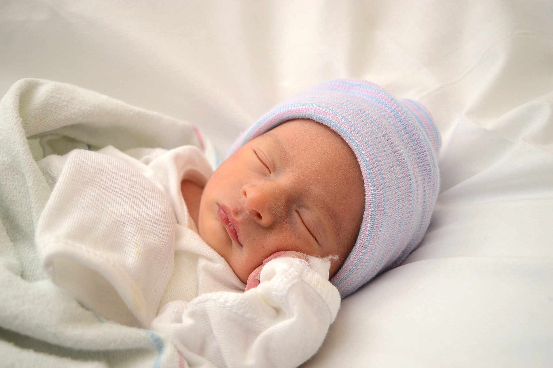 Samuel is registered to the contest to win money with this photo: newborn, baby, sleeping, hat, white_clothing, blanket, soft, infant, resting, cute, peaceful, portrait, closeup, indoors, child, sleep, headwear, cozy, skin, wrapped