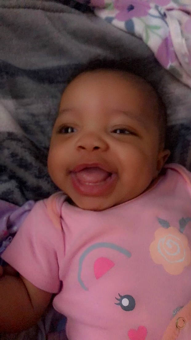 Kinzlee is registered to the contest to win money with this photo: baby, cheek, chin, eye, eyebrow, face, facial_expression, forehead, happy, head, lip, mammal, mouth, nose, organ, person, product, skin, sleeve, smile