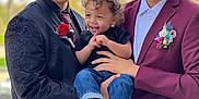 Jeremiah is registered to the contest to win money with this photo: child, toddler, smiling, two_men, suit, jacket, tie, flower, boutonniere, outdoor, portrait, people, curly_hair, happy, holding, casual, formal, celebration, nature, daylight