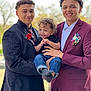 child, toddler, smiling, two_men, suit, jacket, tie, flower, boutonniere, outdoor, portrait, people, curly_hair, happy, holding, casual, formal, celebration, nature, daylight