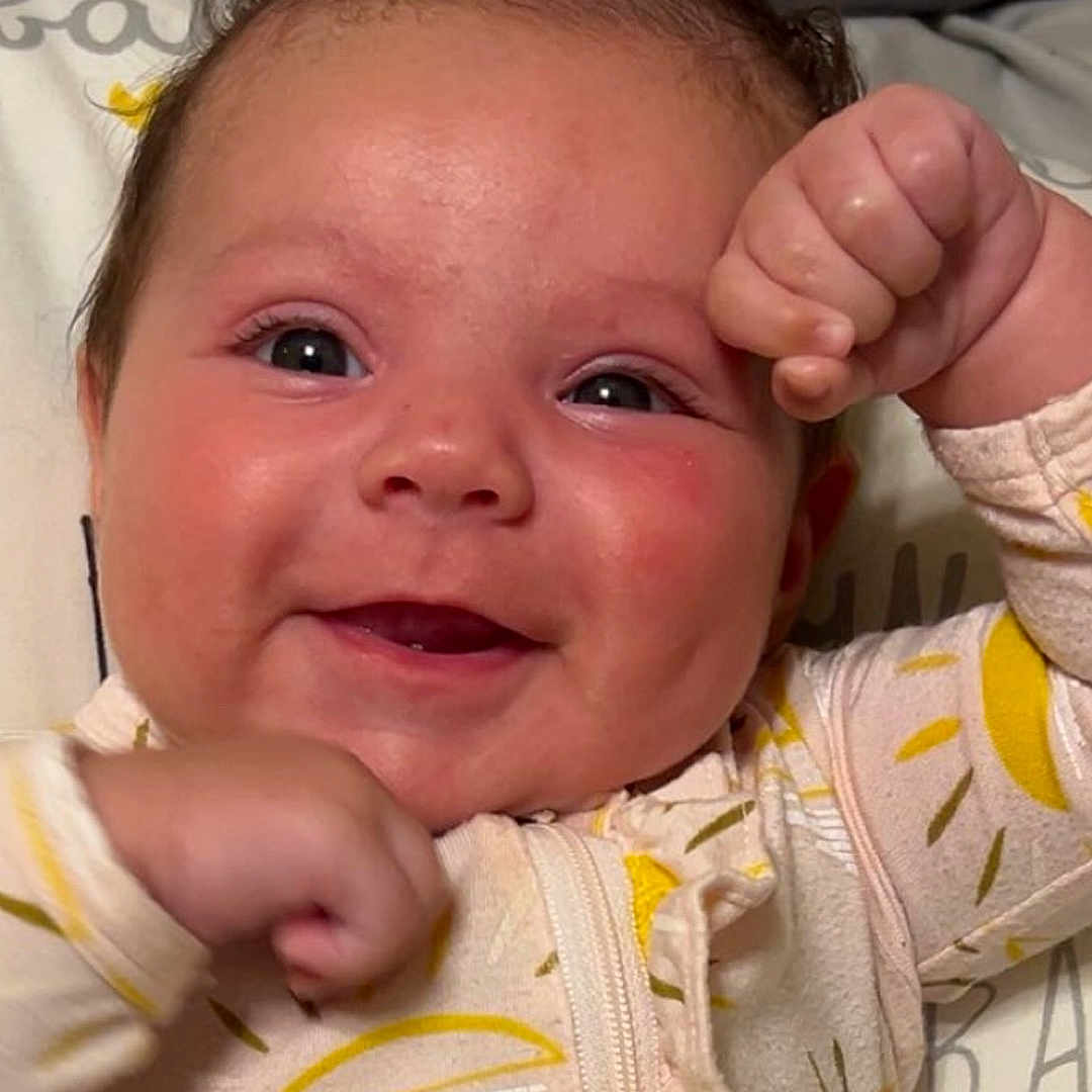 Lillian is registered to the contest to win money with this photo: accessories, baby, babylaughing, bodypart, cushion, earring, face, finger, hand, happy, head, homedecor, jewelry, laughing, newborn, person, photography, portrait, quilt, smile
