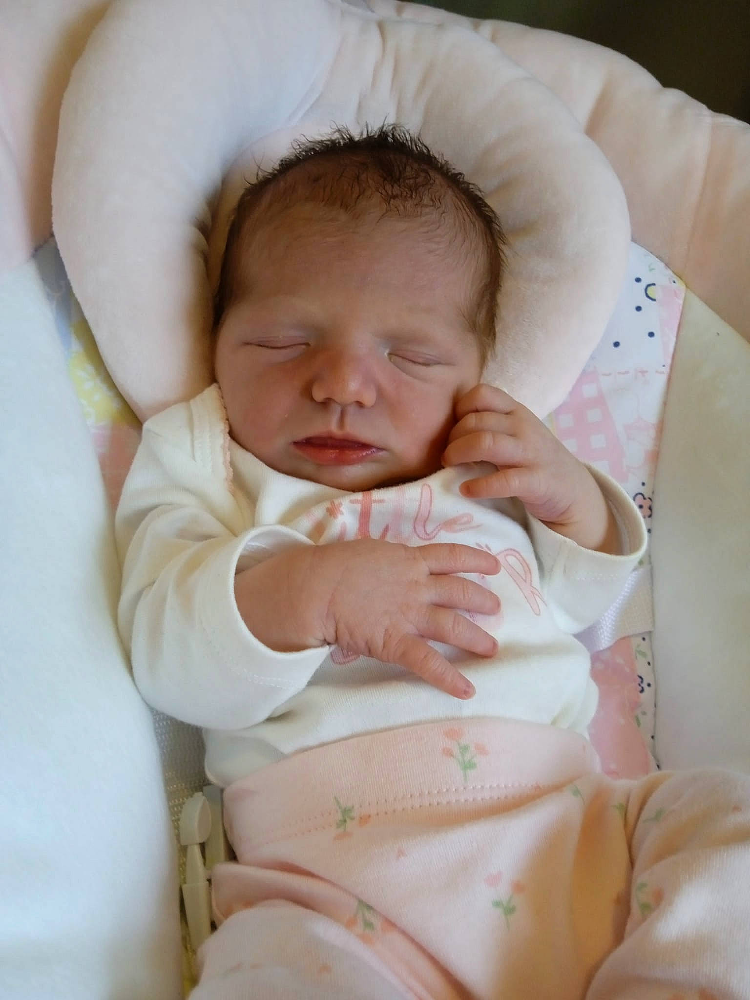 Arya is registered to the contest to win money with this photo: abdomen, arm, baby, baby_products, baby_sleeping, baby_toddler_clothing, cheek, child, comfort, eye, finger, hand, linens, nail, person, sitting, skin, sleeve, stomach, thumb