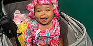Jyleenia joined the competition — help win amazing prizes! accessory, baby, baby_lotion, bottle, child, clothing, cute, face, gray, happy, hat, indoor, infant, person, pink, sitting, smiling, stroller, toy, yellow