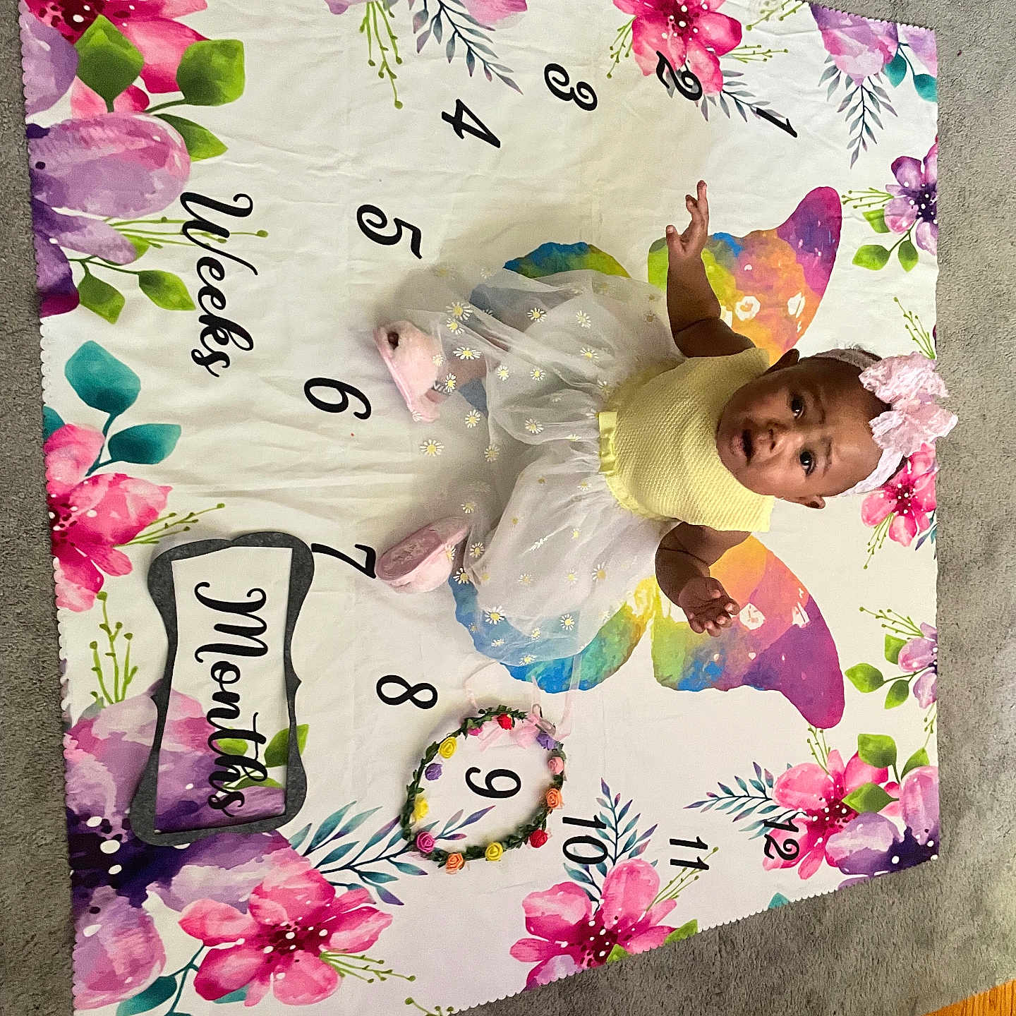Jyleenia joined the competition — help win amazing prizes! baby, carpet, child, colorful, cute, floral_pattern, flower_crown, indoor, infant, milestone, milestone_blanket, months, pink_booties, pink_bow, portrait, sitting, weeks, white_tutu, wooden_floor, yellow_top