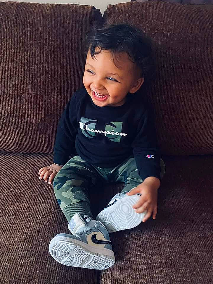 Grayson joined the competition — help win amazing prizes! arm, baby, baby_toddler_clothing, cheek, comfort, couch, flash_photography, flooring, happy, human_body, human_leg, joy, knee, person, sitting, skin, sleeve, smile, t_shirt, tints_and_shades