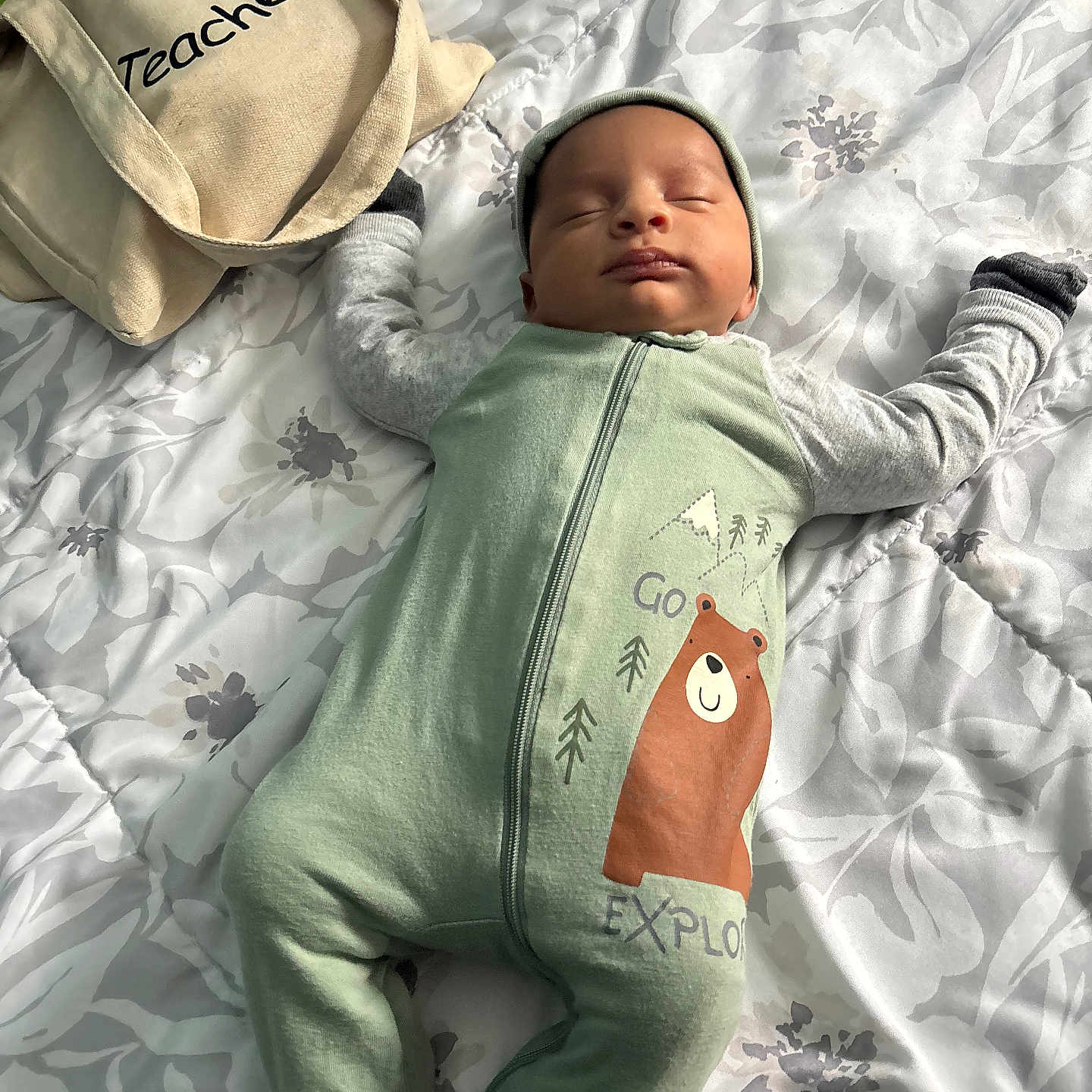 Idan is registered to the contest to win money with this photo: baby, bear_graphic, bed, blanket, cute, fabric, floral_bedspread, hat, indoors, infant, mittens, nap, newborn, onesie, patterned_bedding, peaceful, sleeping_baby, soft_light, tote_bag, zipper