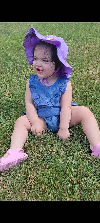 Naiya joined the competition — help win amazing prizes! baby_toddler_clothing, blue, child, dress, face, facial_expression, fun, grass, grassland, happy, hat, meadow, people_in_nature, person, pink, plant, skin, smile, summer, sunlight
