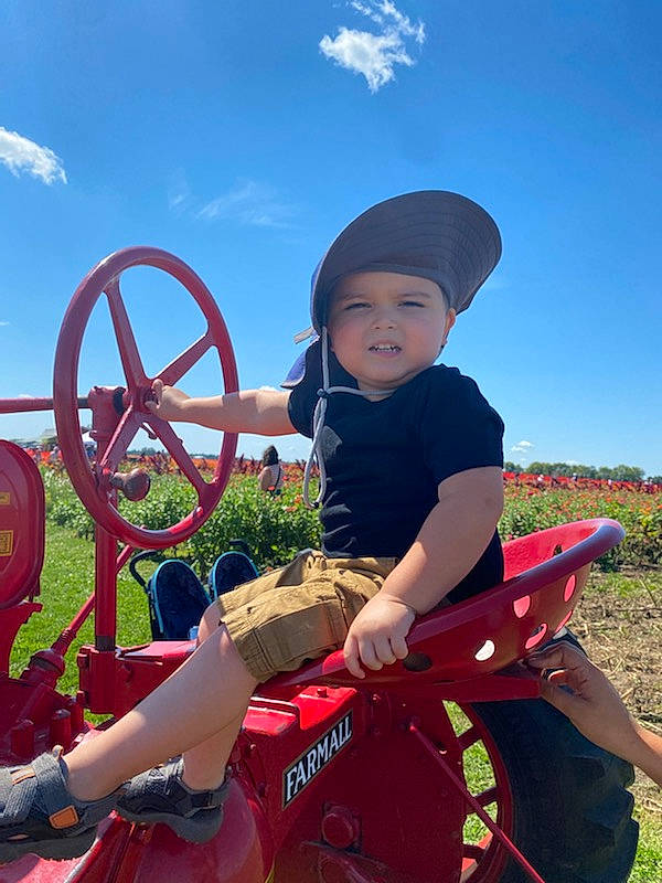 Jaxon joined the competition — help win amazing prizes! automotive_tire, cloud, fun, grass, grassland, happy, hat, headwear, landscape, leisure, mammal, motor_vehicle, person, plant, recreation, rural_area, sky, steering_wheel, toddler, travel