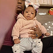 Miracle joined the competition — help win amazing prizes! baby, child, adult, person, hoodie, bow, headband, striped_pants, bear_patch, pink_shoelaces, sitting, hand, curtains, indoor, furniture, home, cozy, casual_clothing, portrait, family