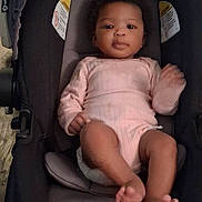 Miracle is registered to the contest to win money with this photo: baby, infant, child, car_seat, baby_carrier, onesie, pink_clothing, portrait, face, eyes, hands, feet, toes, hair, cute, relaxed, indoor, cozy, stroller, newborn