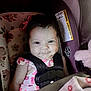 baby, blanket, car_seat, child, child_safety, cute, dress, face, floral, happy, indoors, infant, person, pink, safety, seat, seatbelt, smile, toy, young_child